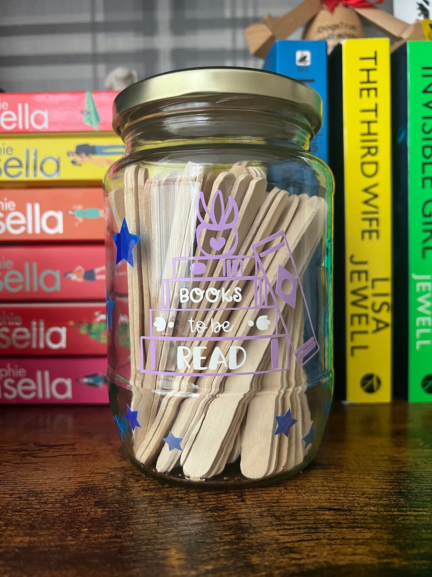 Books to be read and Tracker glass jars with gold lid