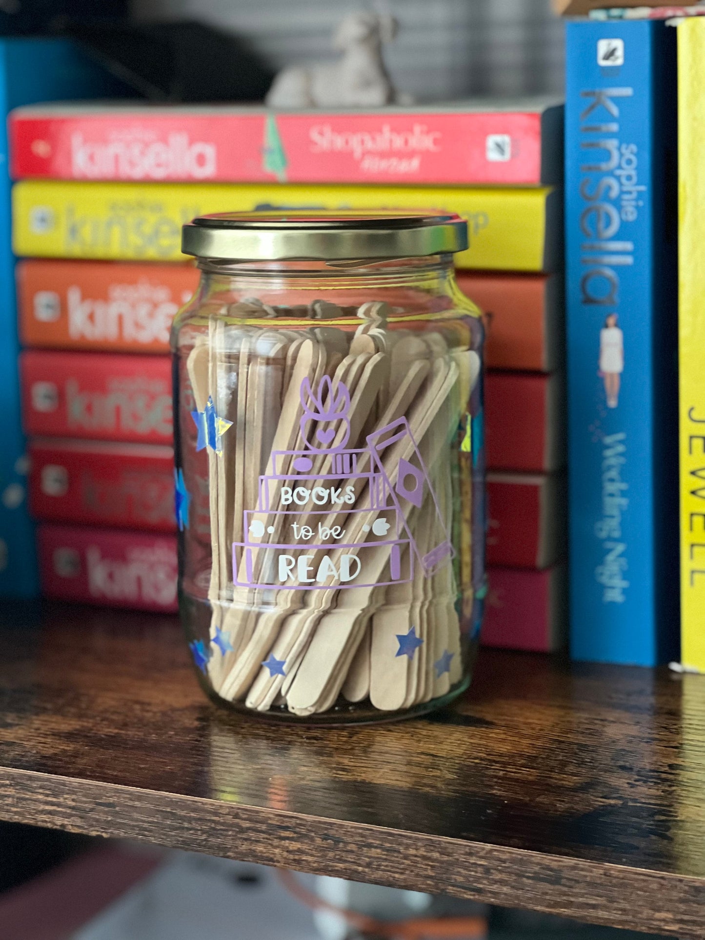 Books to be read and Tracker glass jars with gold lid