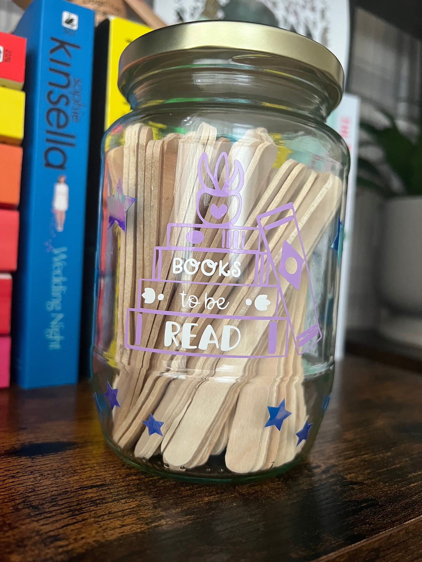 Books to be read and Tracker glass jars with gold lid